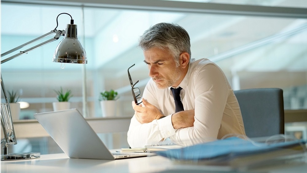 Consultant overlooking a laptop