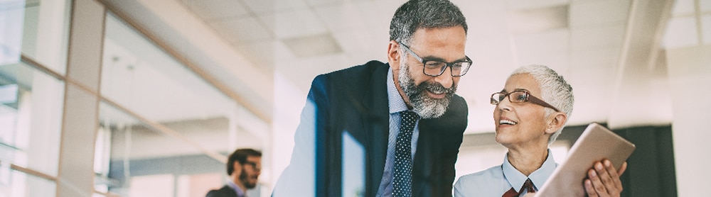 Two professionals looking at tablet screen