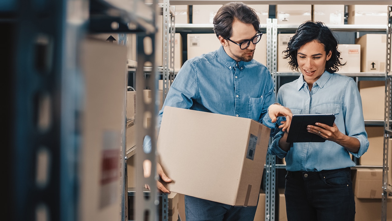 Two people in a retail storage room