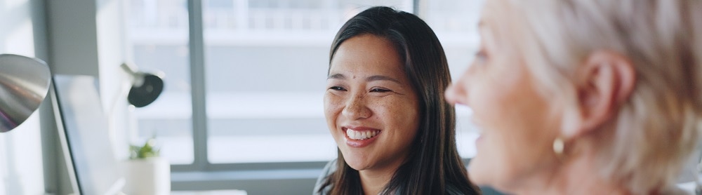 Two professionals looking at a system at a desk