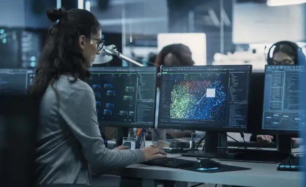 Female AI developer using Artificial Intelligence software on a computer