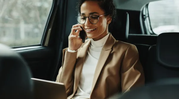 Business executive on a phone in a car