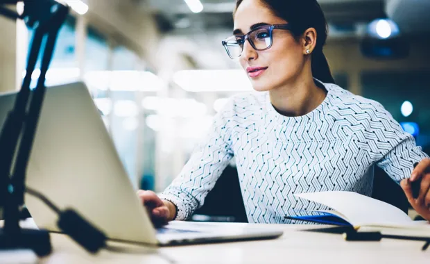 Business woman reading laptop
