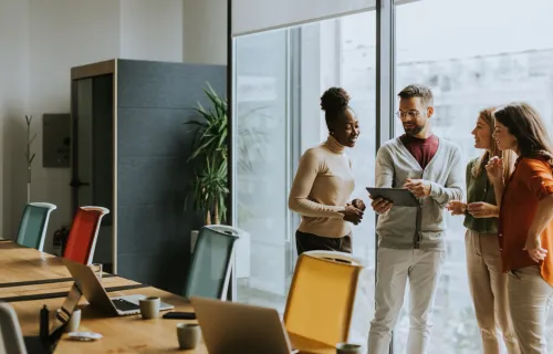 Colleagues discussing AI literacy