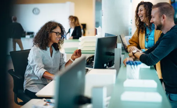 Consultant assisting customers at a public desk