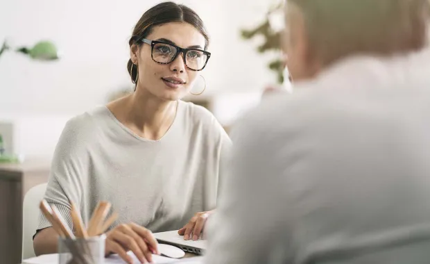 Executive talking to colleague