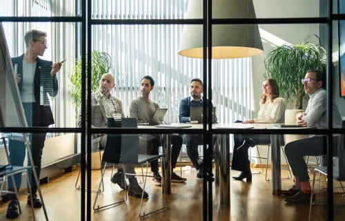 Professionals in a meeting discussing agile techniques