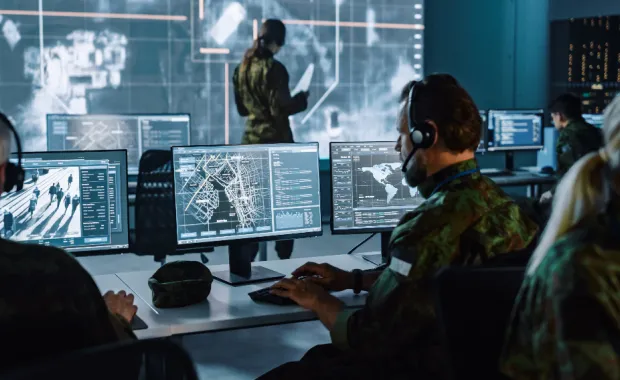 Government professionals working in front of computer screens.