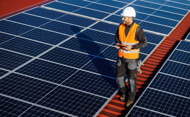 Man walking on solar pannel roof