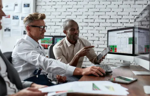 Employees looking at screen together