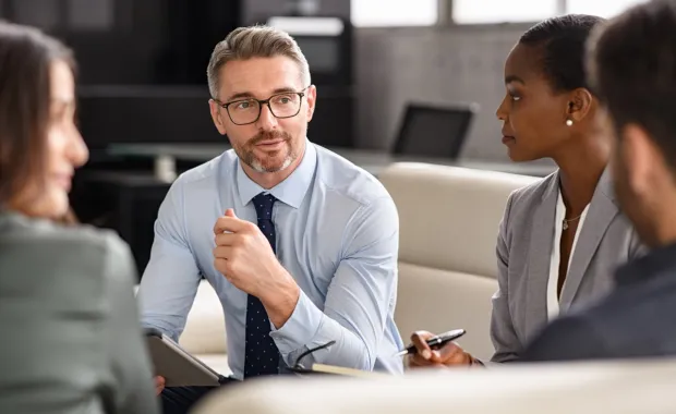 male consultant sitting and advising others