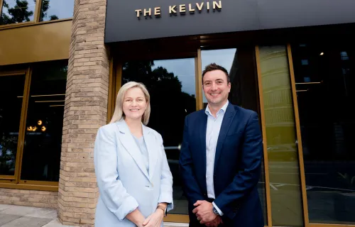 Man and woman stood outside CGI's New Belfast office in The Kelvin
