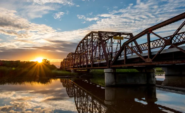 view of a metal bridge at sunrise