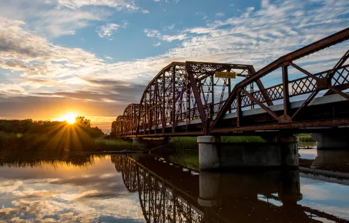 view of a metal bridge at sunrise