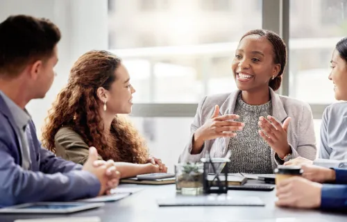 A team of professionals taking a discussion in a meeting setting