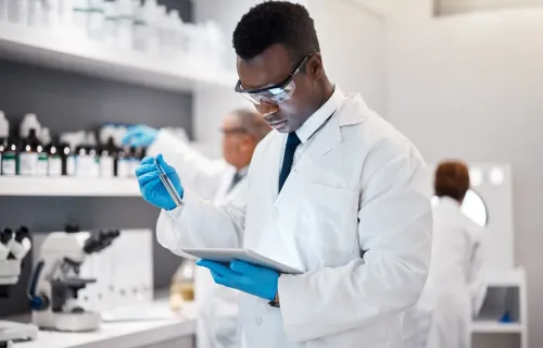 Technician in lab with tablet for medical analysis and digital innovation