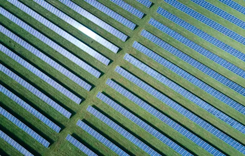 aerial view of a solar farm in a green field