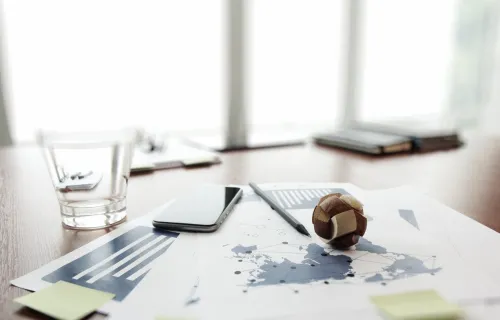 Wooden globe placed on global map